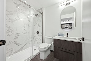 Shower, hair dryer, towels, toilet paper