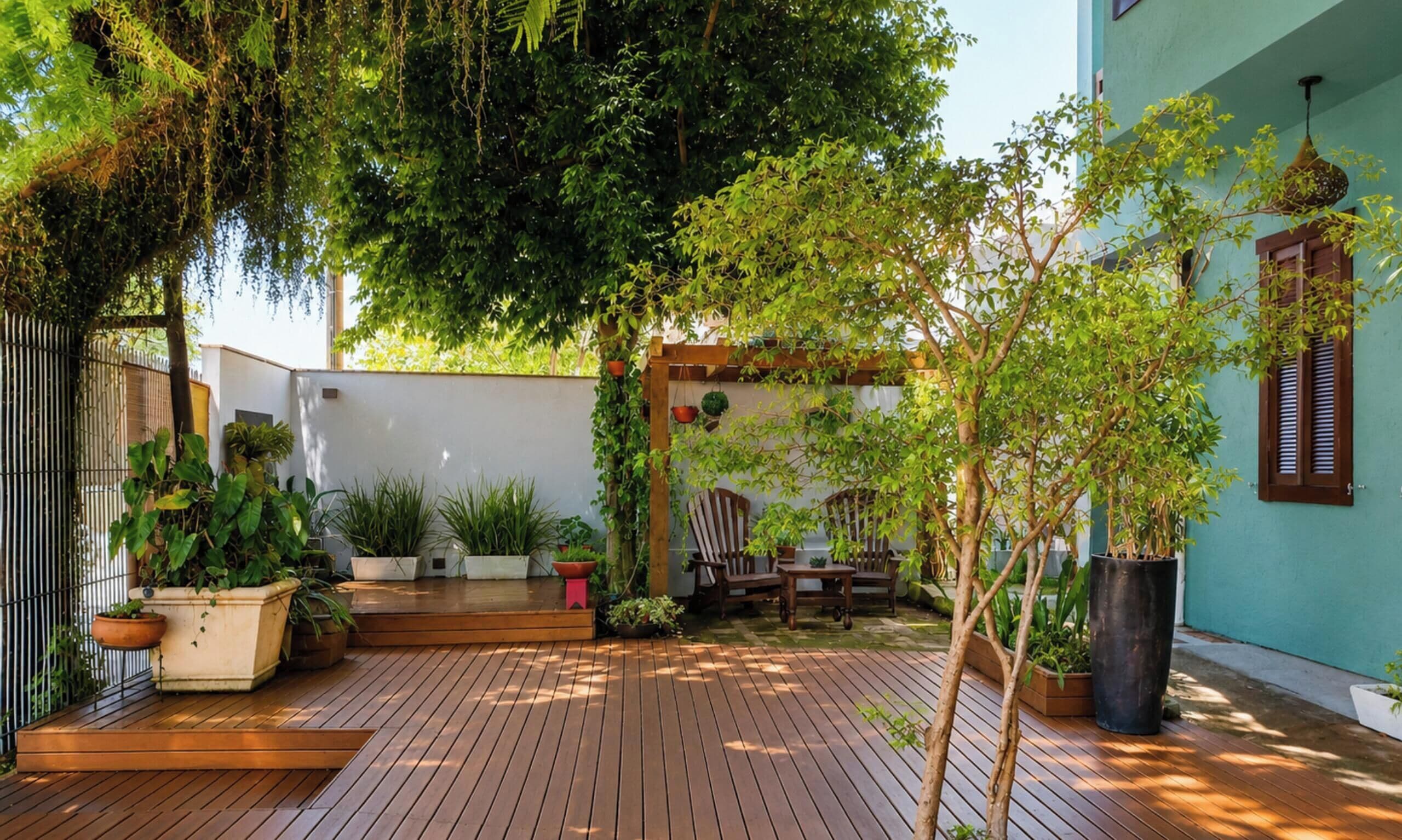 A wooden deck with potted plants and outdoor furniture.