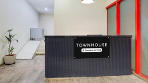 A reception area with a sign indicating 'TOWNHOUSE Company-Serviced'. - Classic With Balcony Hotel Town Plaza (Pune)