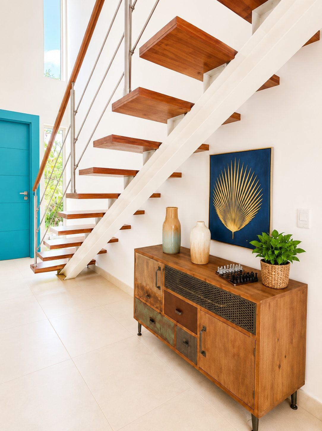 A staircase with wooden steps and white railings, leading to a room with a blue door.