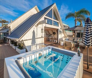 A modern house with a pool, outdoor seating, and a sloped roof. - Neptune Ocean View Masterpiece (Encinitas)