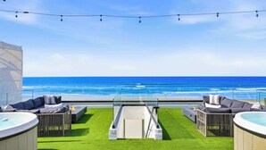 A rooftop terrace with a clear view of the ocean, outdoor seating, and a hot tub. - Luxury oceanfront fourplex with roof deck, sleeps 22 (San Diego)