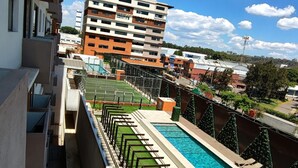 A swimming pool with a view of a multi-story building in the background. - Beautiful 3 bedroom apartment, Petapolis zone 12 Guatemala (Ciudad de Guatemala)