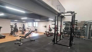 A gym with exercise equipment, a mezzanine level, and a large window. - Beautiful 3 bedroom apartment, Petapolis zone 12 Guatemala (Ciudad de Guatemala)
