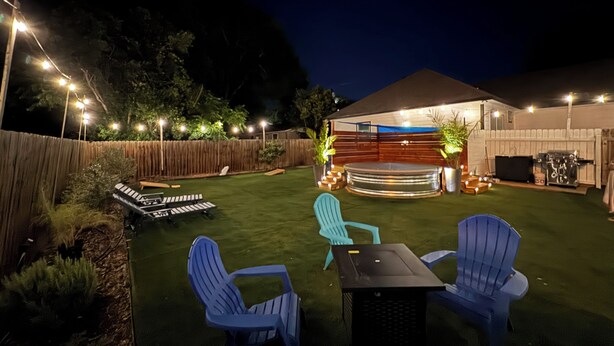A backyard with a covered outdoor seating area, a grill, and a keyboard on the grass. - Gem On Pearl w/ Pool - Walk to Downtown Lockhart (Lockhart)