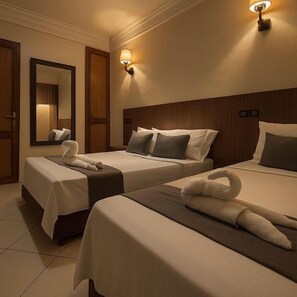 A hotel room with two beds, a large mirror, and wall-mounted lighting. - Isni appart hotel (Agadir)