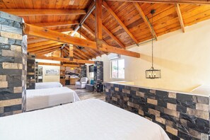 A hotel room with a high wooden ceiling, stone walls, and two beds. - Hotel Casa Patrón Parras  (Parras de la Fuente)