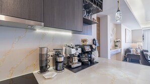 A modern kitchen with a coffee machine, espresso machine, and a coffee press. - Sonoran Star One (Puerto Peñasco)