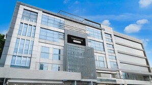 A modern building with a sign reading 'Townhouse Company Services.' - Deluxegrace Complex (Hyderabad)