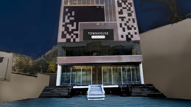 A modern building with a sign reading 'TOWNHOUSE' and a staircase leading to the entrance. - Super Townhouse JP Nagar Miyapur (Hyderabad)