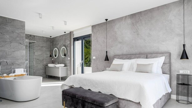 A modern bedroom with a large bed, a bathtub, and a walk-in shower. - Estate With Jacuzzi, Gym (Omis)
