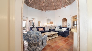 A spacious living room with a high ceiling, a fireplace, and a dining area. - Playa Sin Fin (Puerto Penasco)