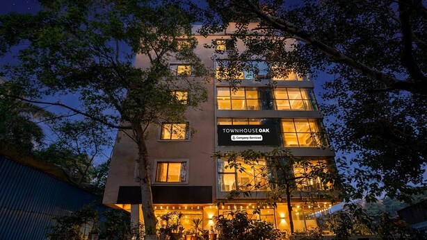 A multi-story building with a sign reading 'TOWNHOUSE OAK.' - Deluxe Hotel Kapil Residency (Pune)