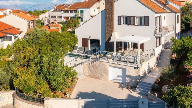 A modern two-story house with a swimming pool, a covered patio, and a view of the surrounding neighborhood. - Villa Mila Near Beaches & Center (Supetar)