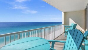 A balcony with a view of the ocean, wooden deck, and turquoise chairs. - Majestic Beach Towers 2-1704 (Panama City Beach)