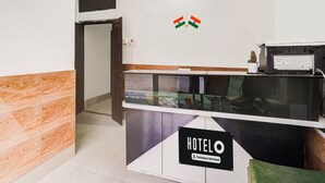 A reception desk with a sign indicating it is a company-serviced hotel.