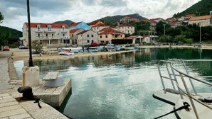A coastal town with stone buildings, a marina, and boats. - Sanktvid Residence (Hodilje)