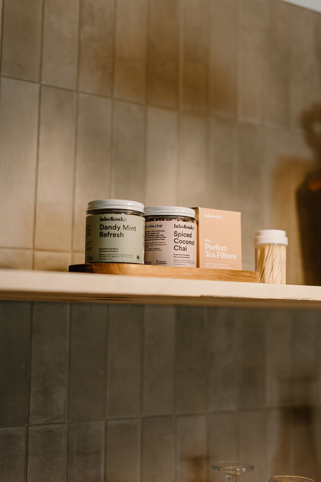 A shelf with tea products and a box of tea filters.