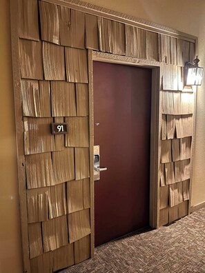 A door with a number plate, a keypad lock, and a wall-mounted light fixture. - Cozy Mtn. Condo, Hot Tub, Garage, Dog Friendly (Mammoth Lakes)