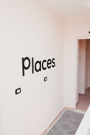 A wall with the word 'Places.' and a geometric pattern on the floor. - Pyramids View • places (محافظة الجيزة)