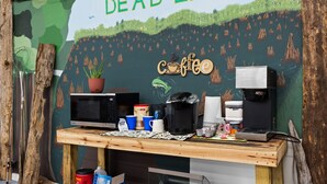 A coffee stand with a sign reading 'Welcome to Dead Lakes' and a coffee machine.