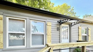 A house with three windows, a door, and a wooden deck. - Cozy 1BR Entire Unit in W. Plains, nice location! (West Plains)