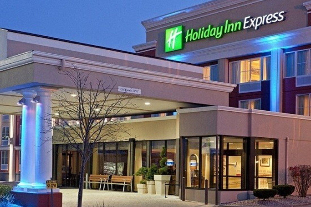 A Holiday Inn Express hotel with a modern facade, large windows, and a prominent entrance.