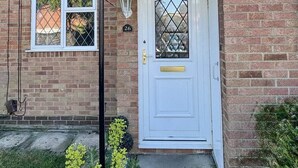 A two-story brick house with a white front door, a small porch, and a number '26' on the door. - Homely 2 bedroom house, parking (Kidlington)