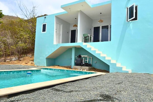 A modern two-story building with a swimming pool, a staircase, and a water filtration system. - Santirome 2 - Quiet Caribbean Studio for Couples (Westpunt)