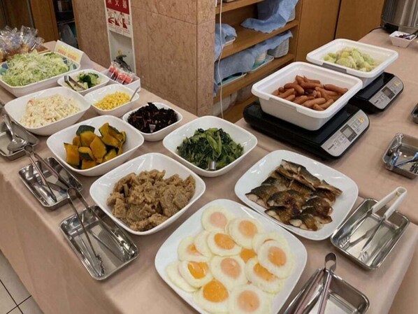 A buffet table with various dishes including vegetables, meats, and eggs. - Toyoko Inn Oyama Eki Higashi-guchi No.1 (Oyama)