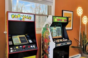 Two arcade machines, one labeled 'PAC-MAN' and the other 'GoonY.'