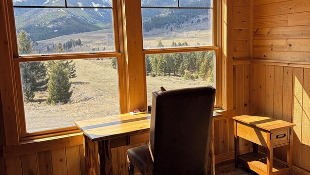 A wooden interior with a desk, chair, and a small table. - Beautiful 3-bedroom barn apartment right next to Yellowstone National Park (Gardiner)