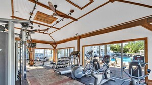 A gym with various exercise equipment, large windows, and a view of an outdoor swimming pool. - 🦩Book Me Baby! Seaglass in Santa Rosa Beach  ~ Golf Cart Included🦩 (Santa Rosa Beach)