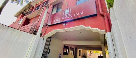 A building with a sign reading 'Yal's Town Inn Hotel & Restaurant.'