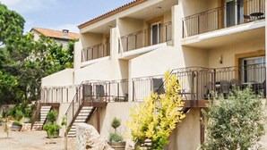 A multi-story building with balconies, a staircase, and outdoor seating. - Gorgeous home in Mirepeisset with outdoor swimming pool (Mirepeisset)