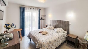 A bedroom with a bed, bedside tables, a desk, and a chair. - Gorgeous home in Mirepeisset with outdoor swimming pool (Mirepeisset)