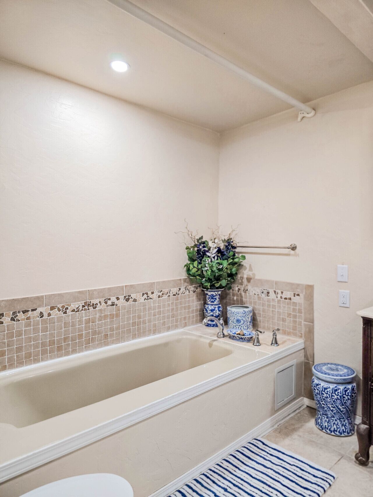 A bathroom with a bathtub, a toilet, and a sink.