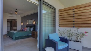 A bedroom with a bed, bedside table, and a nightstand. - Oasis 408: Oasis Riverfront Luxury 2BR Infinity Pool & Views (Puerto Vallarta)