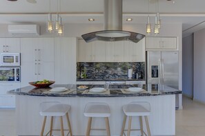 A modern kitchen with a marble island, stainless steel appliances, and pendant lighting. - Park Condo Zona Romántica, Terrace+ Infinity Pool (Puerto Vallarta)
