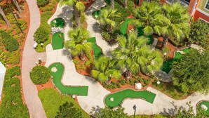 An aerial view of a landscaped garden with pathways, palm trees, and a pool area. - Worldmark Orlando Kingstown Reef Studio Deluxe (Orlando)