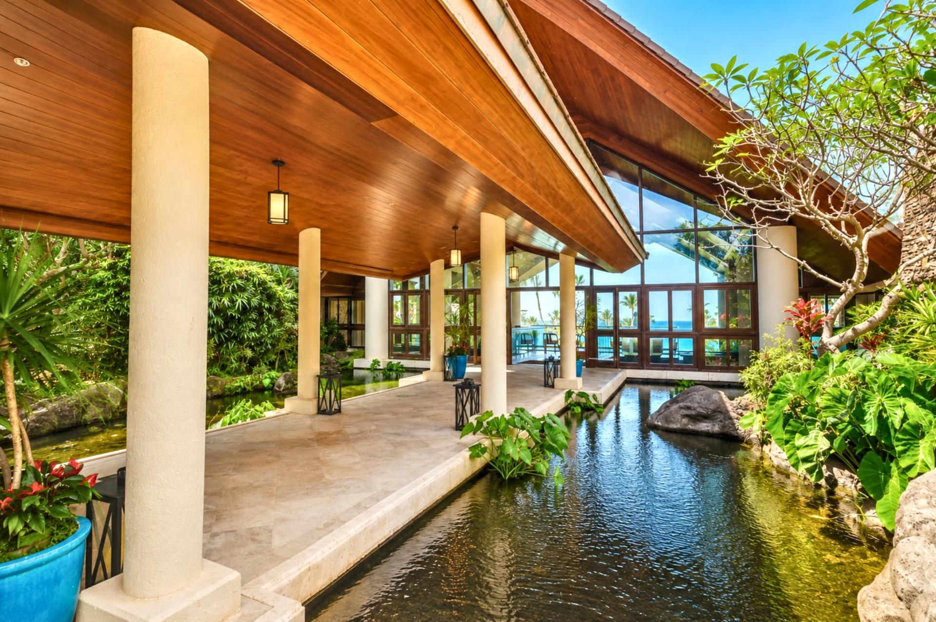 Stroll peaceful garden pathways with tranquil koi ponds, lush tropical plants & calming resort water features