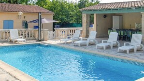 A swimming pool with white lounge chairs and a covered patio area. - Nice home in Regusse with private swimming pool, can be inside or outside (Regusse)