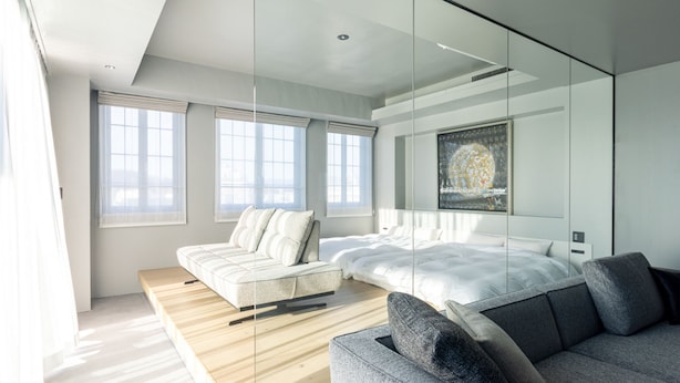 A modern bedroom with a bed, sofa, and artwork on the wall. - asuwagawaritoa-to asunowa (Fukui)