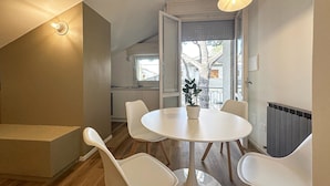 A modern kitchen with a dining area, a staircase, and a view of the outside. - 1 bedroom nice apartment in Cattolica (Cattolica)
