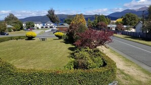 A residential area with houses, a well-maintained lawn, and a road.