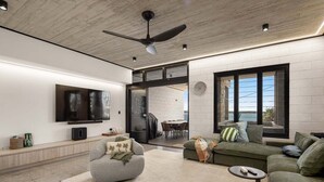 A modern living room with a flat-screen TV, a ceiling fan, and a large window offering a view of the outdoors.