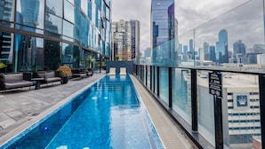 A rooftop pool with a city view, lounge seating, and a sign indicating a pool depth of 1.2m. - Southbank Skyline Suite - City Views & Prime Location (Southbank)