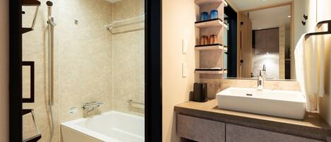 A modern bathroom with a bathtub, a sink, and a mirror.