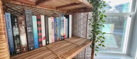 A bookshelf with books and a plant.