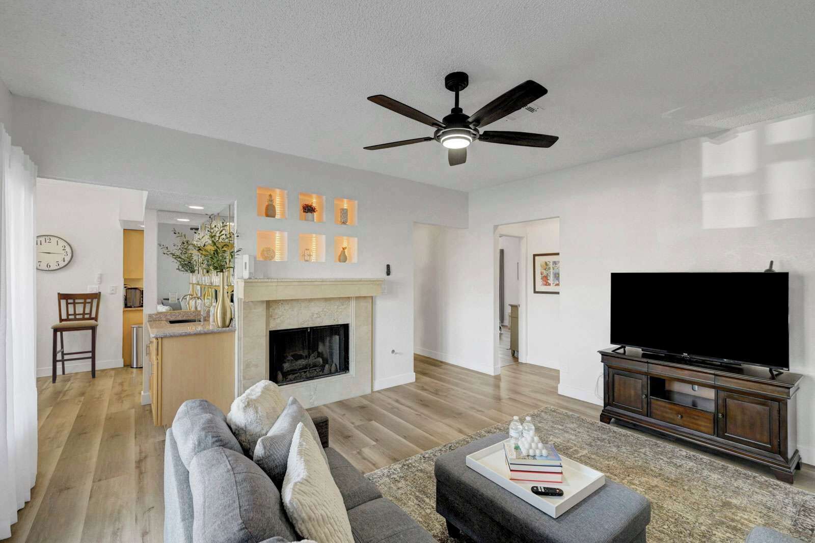 A living room with a fireplace, a television, and a sofa.